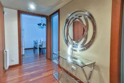 a mirror on a wall in a room with a table at Afurada premium apartment by Porto City Hosts in Vila Nova de Gaia