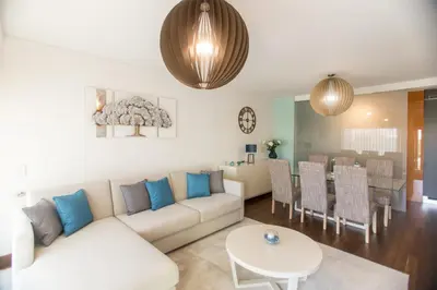 a living room with a couch and a table at Afurada premium apartment by Porto City Hosts in Vila Nova de Gaia