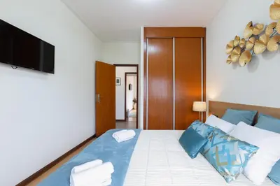 a bedroom with a bed with blue and white pillows at Host Wise - Deluxe Bright Flat with Netflix in Porto