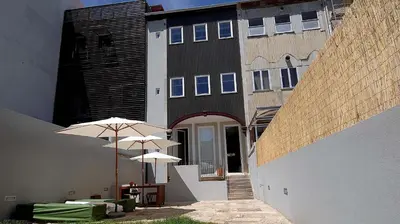 a building with two umbrellas in front of it at So Cool Hostel Porto in Porto