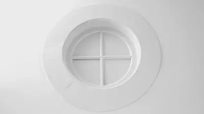 a round window in a white wall at So Cool Hostel Porto in Porto