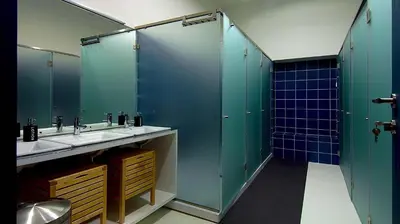 a bathroom with two sinks and green stalls at So Cool Hostel Porto in Porto