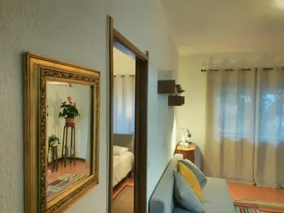 a mirror in a room with a couch and a bedroom at ! Free Parking Street ! Ground Floor with Washer! in Porto