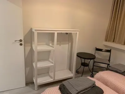 a bedroom with a white book shelf next to a bed at City Heart Place 1 in Porto