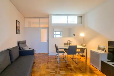 a living room with a couch and a table at Casa da Alegria- Downtown by Oporto Soul in Porto