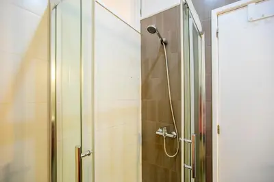 a bathroom with a shower with a glass door at Casa da Alegria- Downtown by Oporto Soul in Porto