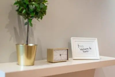 a clock and a picture on a shelf with a vase at GuestReady - City Blossom in Porto