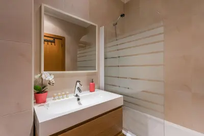 a bathroom with a sink and a mirror at GuestReady - City Blossom in Porto