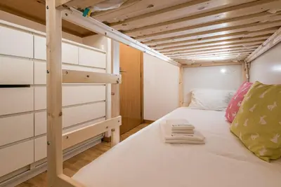 a small bedroom with a bunk bed with a ladder at GuestReady - City Blossom in Porto