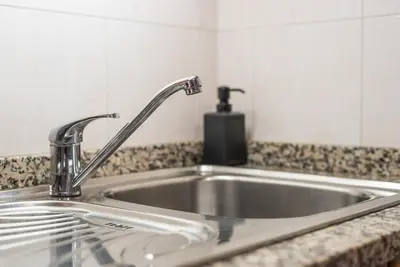 a kitchen sink with a faucet on a counter at GuestReady - City Blossom in Porto