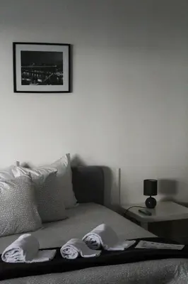 a bedroom with a bed with slippers on it at Silva's Guest House in Vila Nova de Gaia