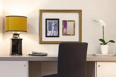 a desk with a lamp and a black chair at B The Guest Downtown in Porto