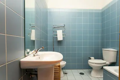 a blue bathroom with a sink and a toilet at Porto by the River 1 in Porto