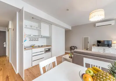 a living room with a table and a couch at Look At Me - Serviced Lofts & Studios in Porto