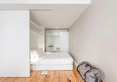 a white dining room with a white table and chairs at Look At Me - Serviced Lofts & Studios in Porto