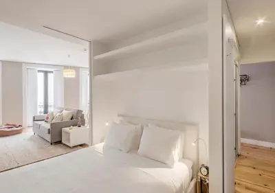 a living room with a couch and a tv at Look At Me - Serviced Lofts & Studios in Porto
