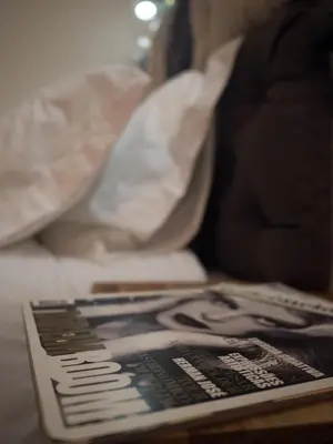 a book sitting on a table next to a bed at All in flat by, city center, skyline in Porto