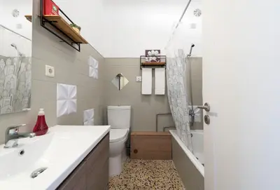 a bathroom with a sink and a toilet and a shower at All in flat by, city center, skyline in Porto