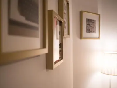 a room with a lamp and pictures on the wall at All in flat by, city center, skyline in Porto