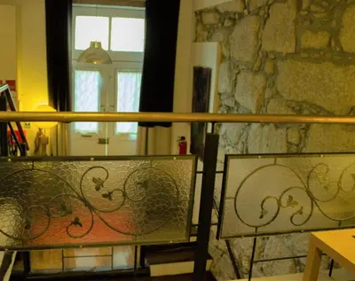 two benches sitting in front of a stone wall at Cosy apartment in Porto city centre – 50 sqm with parking in Porto