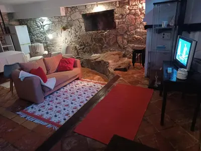 a living room with a couch and a stone fireplace at Cosy apartment in Porto city centre – 50 sqm with parking in Porto