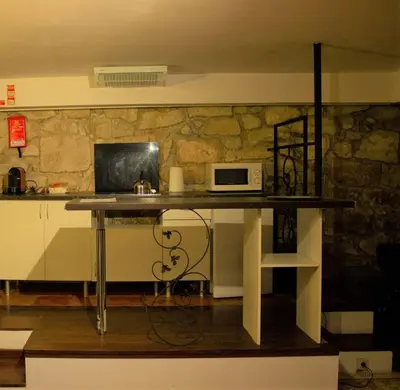 a kitchen with a table with a microwave on it at Cosy apartment in Porto city centre – 50 sqm with parking in Porto