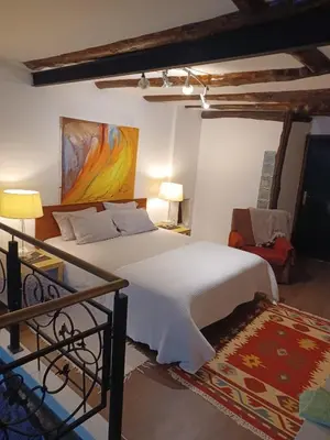 a bedroom with a bed and a painting on the wall at Cosy apartment in Porto city centre – 50 sqm with parking in Porto