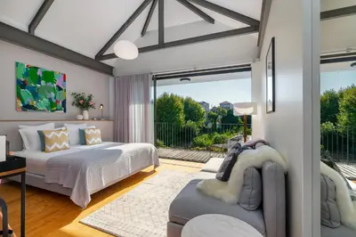 a bedroom with two beds and a living room at Luxury Old Town Oasis for Family and Friends (Daily Breakfast + Housekeeping incl) in Porto