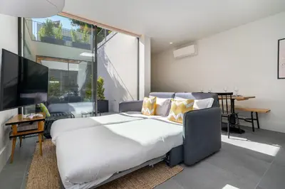 a bedroom with a large bed and a large window at Luxury Old Town Oasis for Family and Friends (Daily Breakfast + Housekeeping incl) in Porto