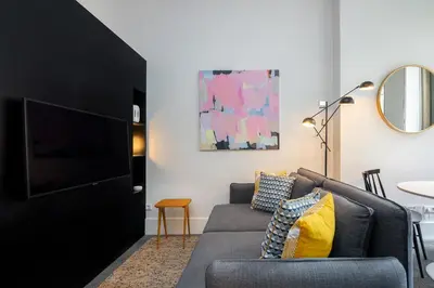 a living room with a couch and a tv at Luxury Old Town Oasis for Family and Friends (Daily Breakfast + Housekeeping incl) in Porto