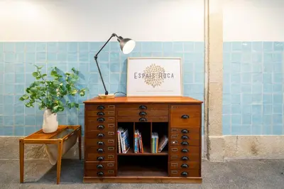 a table with a lamp on top of a wooden dresser at Luxury Old Town Oasis for Family and Friends (Daily Breakfast + Housekeeping incl) in Porto