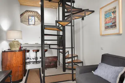 a spiral staircase in a living room with a couch at Porto National Theatre Trendy Houses in Porto