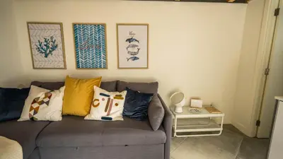 a living room with a gray couch with pillows at CASA DOURO Porto City in Porto