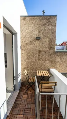 a balcony with two chairs and a table on a building at CASA DOURO Porto City in Porto