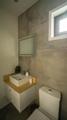 a bathroom with a sink and a toilet and a tv at CASA DOURO Porto City in Porto