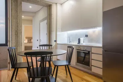 a kitchen with a table and chairs in a room at Tailor's Apartment in Porto