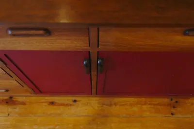 a wooden cabinet with red doors on a wooden floor at aDuquesa - GuestHouse in Porto