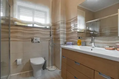 a bathroom with a toilet and a sink and a shower at Metropolitan Gaia-Porto in Vila Nova de Gaia