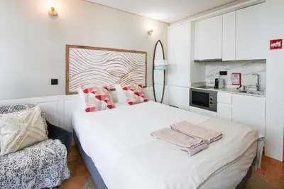 a bedroom with a bed and a flat screen tv on the wall at Charming Studio in Historic Downtown in Porto
