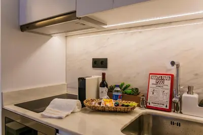 a kitchen counter with a sink and a basket of food at Oldtown Studio in Porto