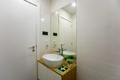 a white bathroom with a sink and a mirror at Oldtown Studio in Porto