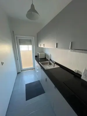 a bathroom with a white toilet and a sink at 26/3 Casa da Música in Porto