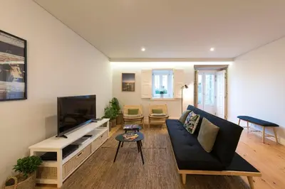 a living room with a couch and a flat screen tv at LovelyStay - Porto Peaceful Living W/ Backyard in Porto