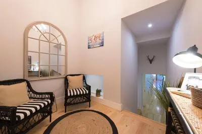 a living room with two chairs and a mirror at LovelyStay - Porto Peaceful Living W/ Backyard in Porto