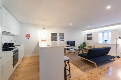 a kitchen and living room with a counter and a couch at LovelyStay - Porto Peaceful Living W/ Backyard in Porto