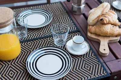 a table with plates of food and bread on it at LovelyStay - Porto Peaceful Living W/ Backyard in Porto