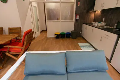 a kitchen with two blue pillows on a table at Change The World Hostels - Porto - Santa Catarina in Porto