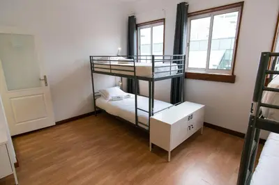 a room with two bunk beds and a window at Change The World Hostels - Porto - Santa Catarina in Porto