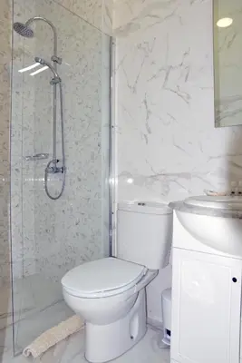 a bathroom with a toilet and a sink and a shower at Hotel Visconde in Porto