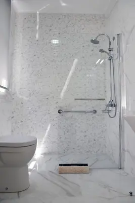 a white bathroom with a shower and a toilet at Hotel Visconde in Porto
